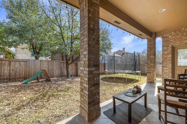 View of patio / terrace with a trampoline and a fenced backyard | Image 27