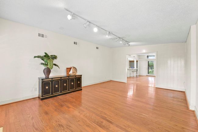 Elegant wood floors flow seamlessly throughout the home. | Image 8