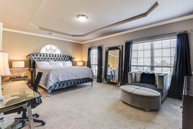 Carpeted bedroom with a tray ceiling and ornamental molding | Image 24