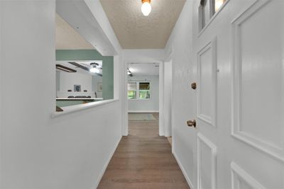 Come inside! Foyer opens to living room & kitchen. | Image 2