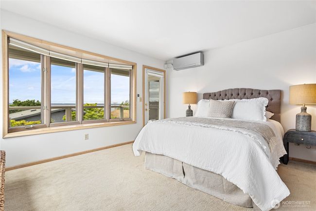 Primary bedroom with views of the bay and access to the deck. | Image 20