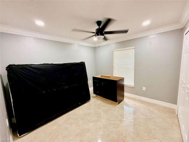 Bedroom featuring light tile patterned floors, ceiling fan, recessed lighting, and ornamental molding | Image 25