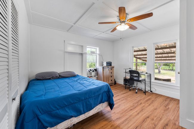 Bedroom featuring light wood-style flooring, baseboards, and a ceiling fan | Image 10