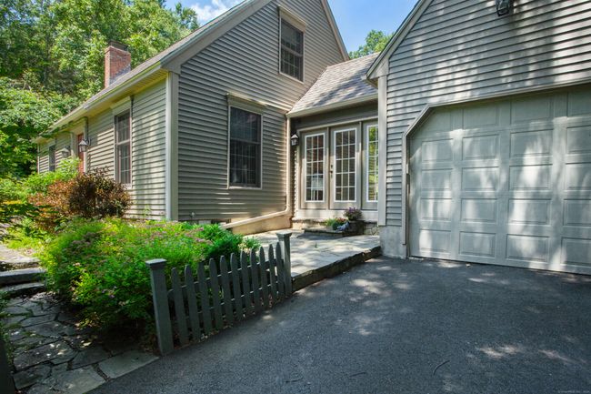 Adorable stone wall and picket fence call you home. | Image 4