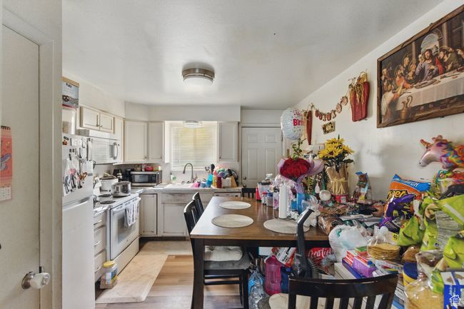Kitchen with light countertops, white appliances, and a sink | Image 21
