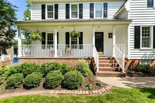 Close up of country front porch and landscaping. | Image 4