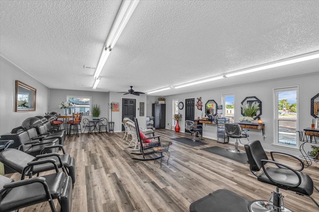 Workout area with a textured ceiling, wood finished floors, a ceiling fan, and visible vents | Image 9