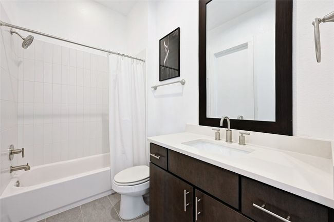 Guest Bathroom with vanity, shower / tub combo, and tile patterned floors | Image 17