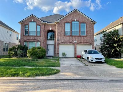 Welcome to this generous 2-story home in Creek Bend Estate. With 5 bedrooms, 3.5 bathrooms, and a 2-car attached garage, this residence boasts timeless brick architecture and elegant arched windows. | Image 1