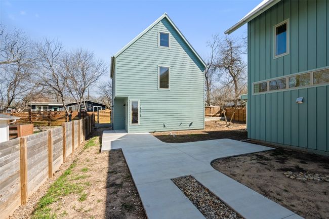Rear view of property featuring board and batten siding, fence private yard, and a patio | Image 33