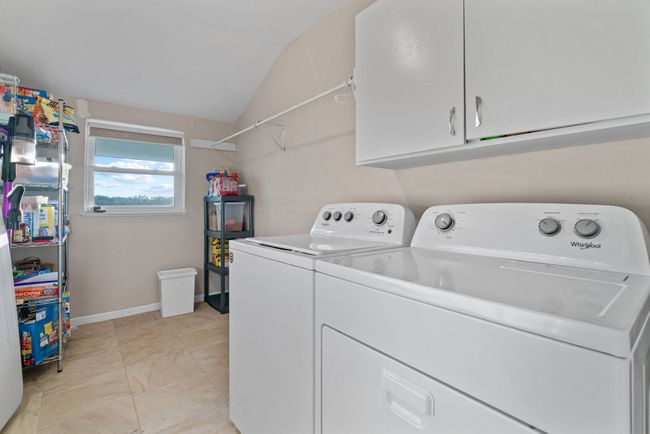 Laundry room featuring cabinet space and washer and dryer | Image 36
