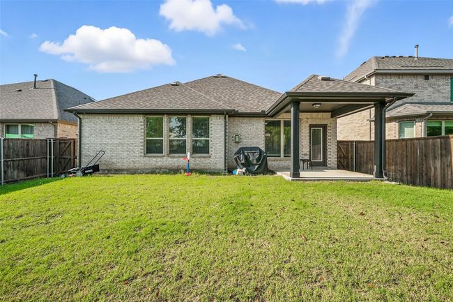 Rear view of property with a patio, roof with shingles, brick siding, and a fenced backyard | Image 30