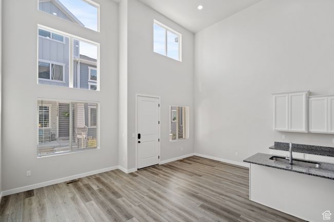 Foyer entrance featuring a towering ceiling, light wood-style flooring, and recessed lighting | Image 8