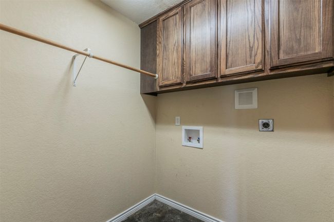 Washroom with baseboards, hookup for a washing machine, cabinet space, and electric dryer hookup | Image 29