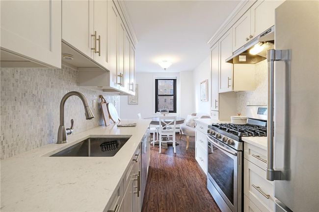 Lovely head on shot of kitchen looking toward windows. | Image 20