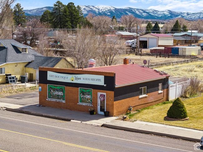 View of building exterior featuring a mountain view and fence | Image 24