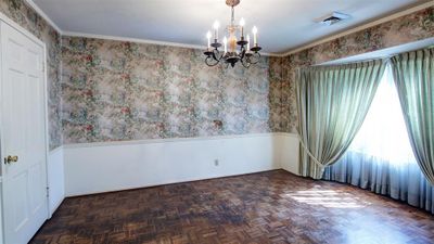 Dining area off the front living area, with double door access to Kitchen. Chandelier, Parquet floors, huge window looks out onto the front of the home. | Image 3