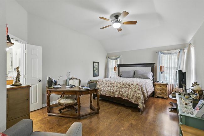 Bedroom with lofted ceiling, wood finished floors, and a ceiling fan | Image 18