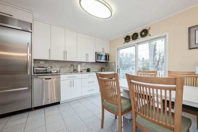 Kitchen with backsplash, ornamental molding, and appliances with stainless steel finishes | Image 6