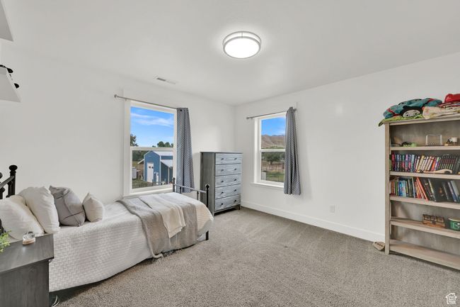 Bedroom featuring carpet flooring and multiple windows | Image 42