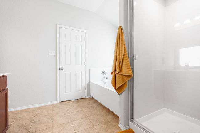 Full bathroom with vanity, a bath, baseboards, and a shower stall | Image 23