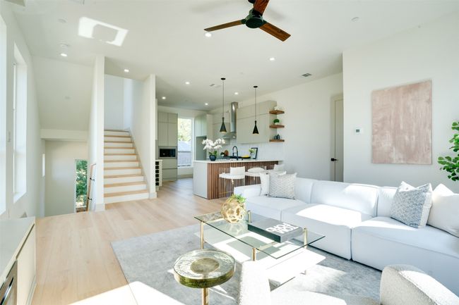 Living room with ceiling fan, sink, and light wood-type flooring | Image 12