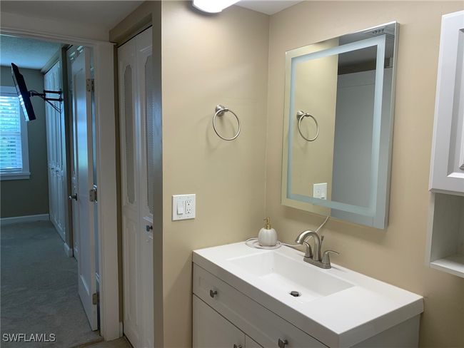 Bathroom featuring new vanity and lighted mirror | Image 14