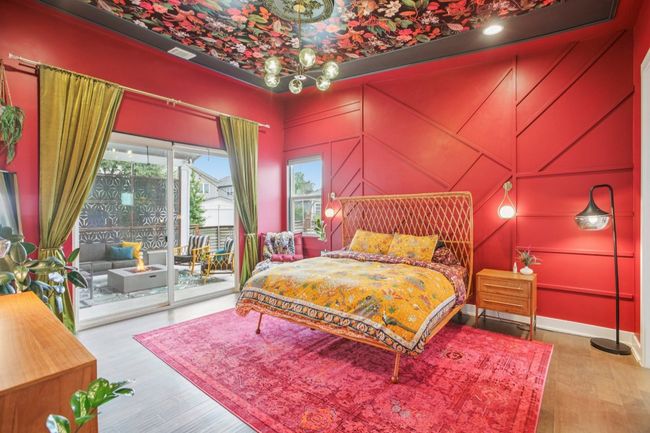 Bedroom with access to exterior, a decorative wall, and wood finished floors | Image 17