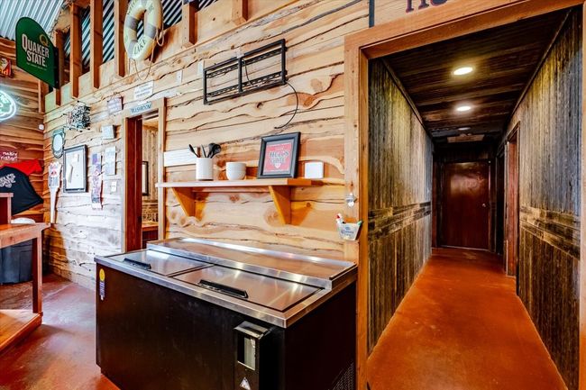 Hall with recessed lighting, wooden walls, and finished concrete flooring | Image 28