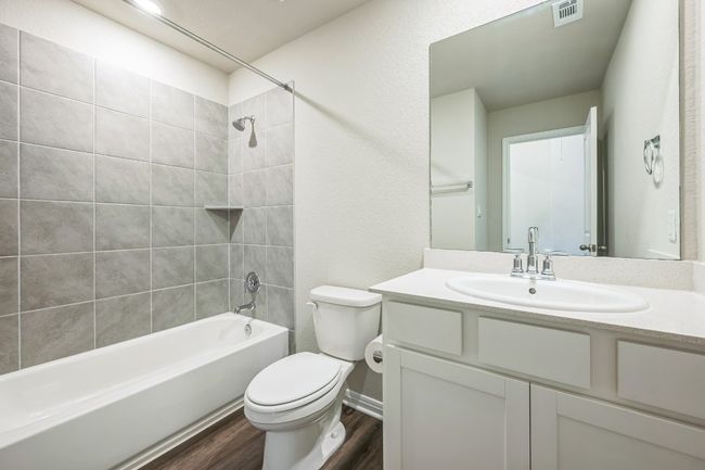 Full bathroom featuring wood finished floors, tub / shower combination, and vanity | Image 9
