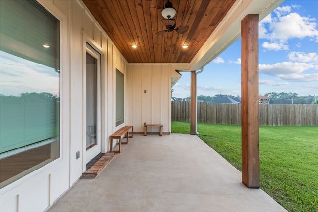 Fenced backyard with a patio and ceiling fan | Image 24