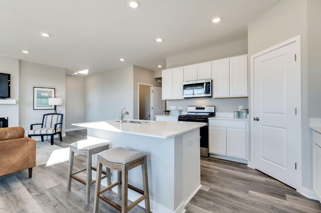 Gas stove, dishwasher, and microwave vented to outside included. Photo is of a previously built model home, finishes and selections will vary. | Image 7