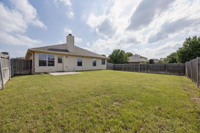 Rear view of house featuring a patio area and a chimney | Image 15