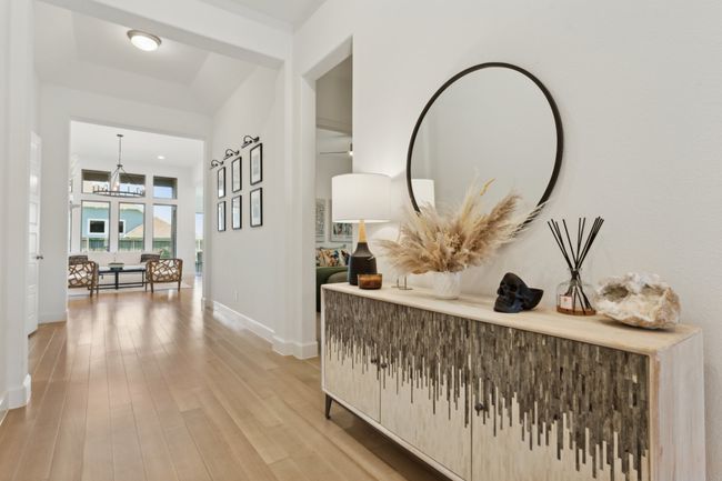 Hallway featuring a chandelier, light wood-style floors, and baseboards | Image 32