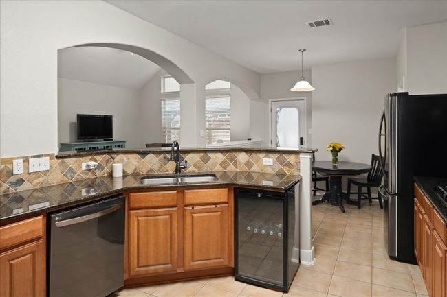 Kitchen has beverage / wine refrigerator. | Image 13