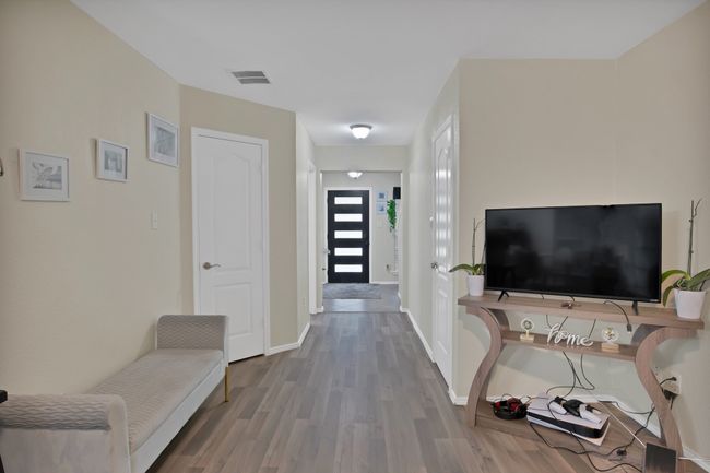 Foyer with visible vents, wood finished floors, and baseboards | Image 16