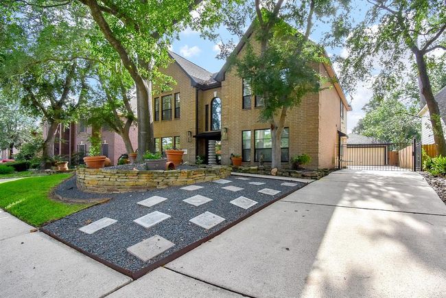 Mature trees and, easy care yard welcome guests to this wonderful home. The long driveway leads to a two car garage, that has never had a car parked in it! The long driveway provides for plenty of parking and offers space for a basketball goal. Notice the sidewalks, another nice neighborhood feature. | Image 4