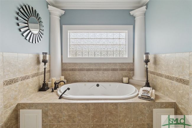 There are two full bathrooms in the primary bath one on either side of the spa tub. | Image 24