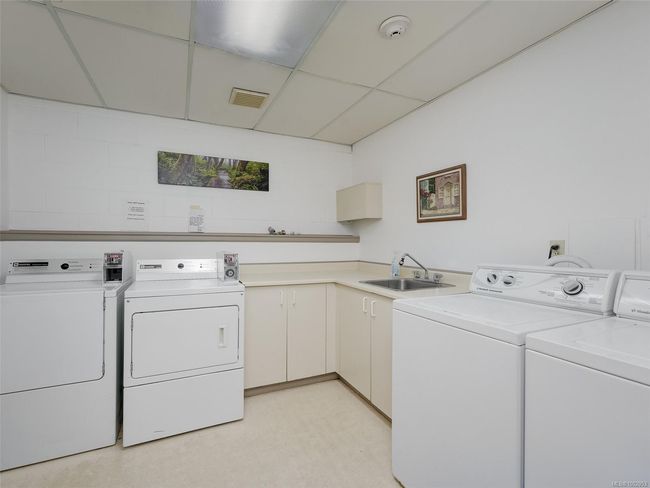 Washroom featuring washer and clothes dryer and cabinet space | Image 21