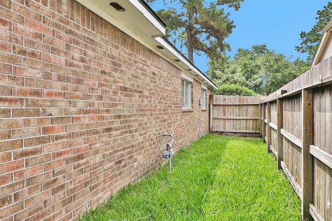 This charming all-brick home offers timeless curb appeal and lasting durability. Set on a well-maintained lot, it features a lush, grassy side yard—ideal for outdoor play or gardening The brick exterior adds warmth and character while providing low-maintenance living. | Image 35