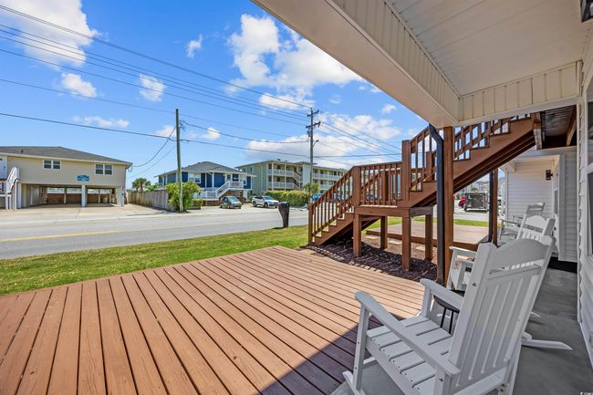 Wooden terrace featuring stairway and a residential view | Image 14