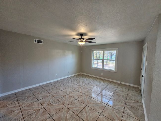 Spare room featuring a ceiling fan and a textured ceiling | Image 29