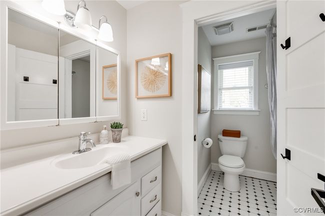 Bathroom with vanity, toilet, baseboards, tile patterned floors, and visible vents | Image 30