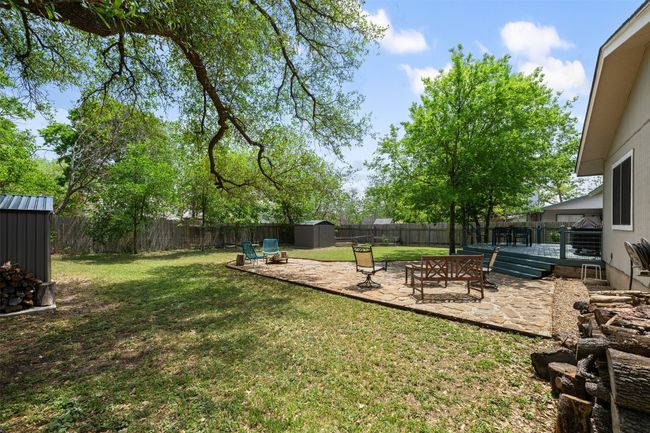 View of yard with a fenced backyard, a patio, an outbuilding, and a shed | Image 25
