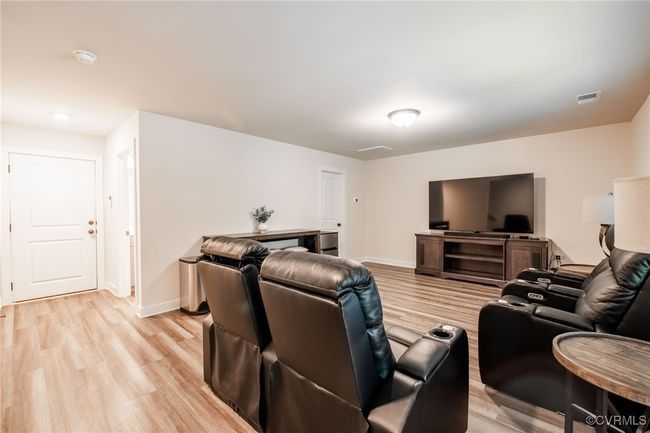 Living room featuring light wood-type flooring and baseboards | Image 35