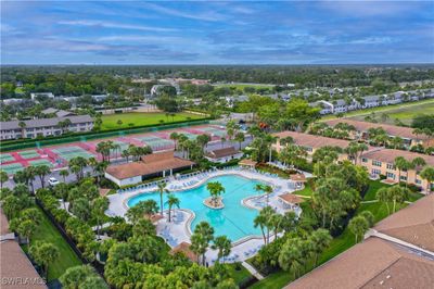 Huge resort styled pool with the tennis and pickle ball courts behind! | Image 1