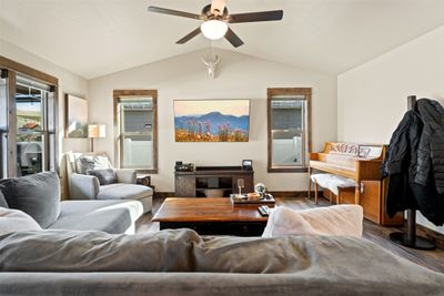 Living room featuring lofted ceiling, hardwood / wood-style floors, and ceiling fan | Image 3