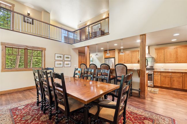 Dining area with light wood-style flooring and a high ceiling | Image 20