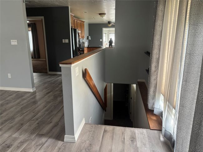 Stairs featuring wood finished floors, baseboards, and a ceiling fan | Image 15