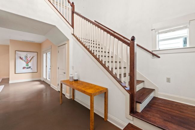 Wooden stairs add some sophistication to the entry. | Image 21